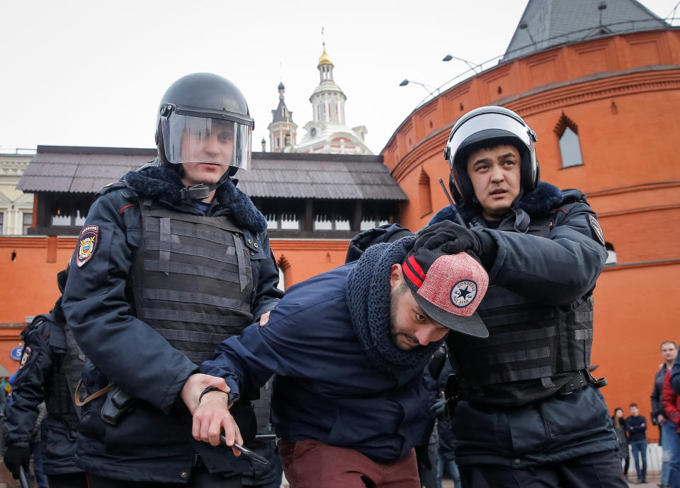 Law enforcement officers detain an opposition supporter in Moscow.