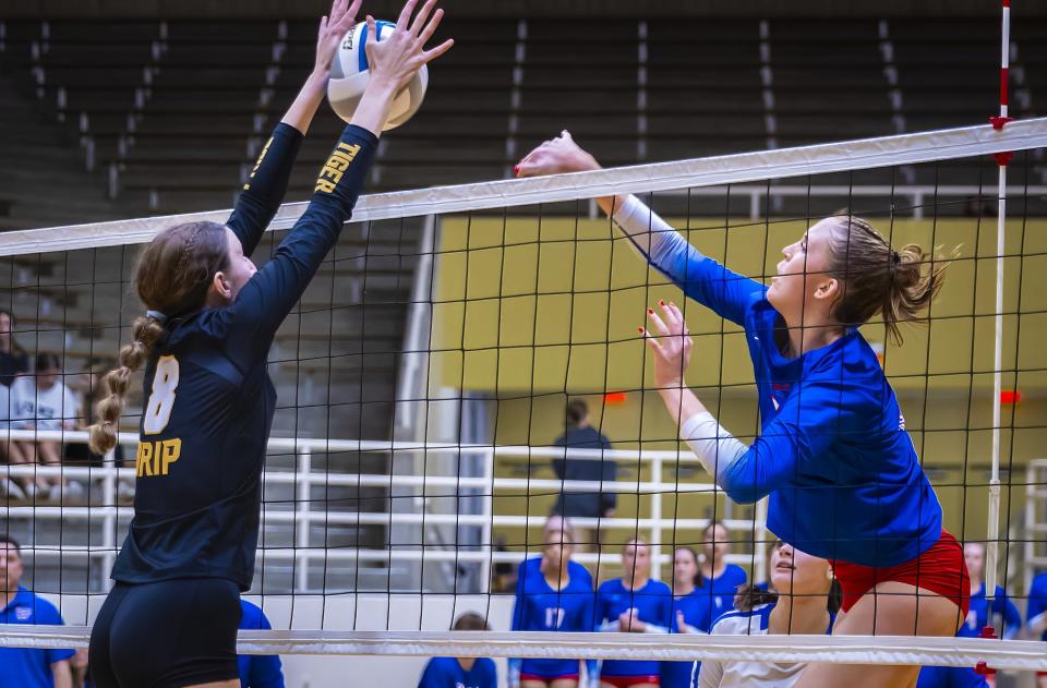 Dripping Springs setter Sydney Lund, left, blocks a shot from Westlake outside hitter Lily Davis, sending the ball back for a quick dunk point during the third set Tuesday night. Lund had two blocks in the victory along with 12 assists; Davis led Westlake with eight kills.