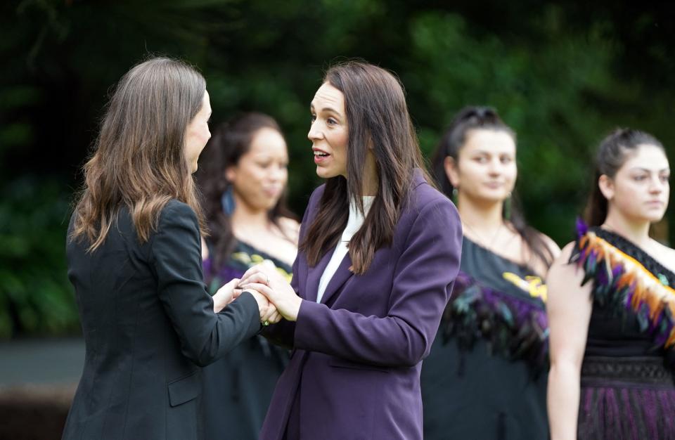 Finlands Prime Minister Sanna Marin (L) is greeted by New Zealand's Prime Minister Jacinda Ardern during a welcome ceremony in Auckland, New Zealand, on November 30, 2022. (Photo by Diego OPATOWSKI / AFP) (Photo by DIEGO OPATOWSKI/AFP via Getty Images)