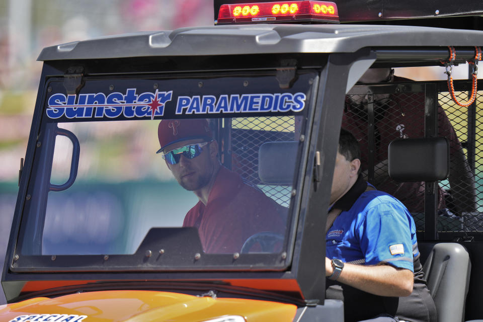 Philadelphia Phillies first baseman Rhys Hoskins is taken off the field after getting injured fielding a ground ball by Detroit Tigers' Austin Meadows during the second inning of a spring training baseball game Thursday, March 23, 2023, in Clearwater, Fla. (AP Photo/Chris O'Meara)