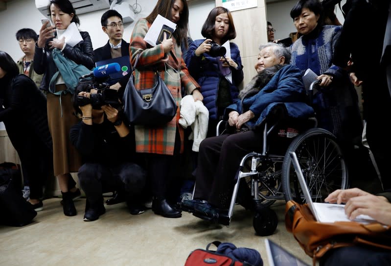 Former South Korean "comfort woman" Gil Won-ok arrives for a news conference in Seoul