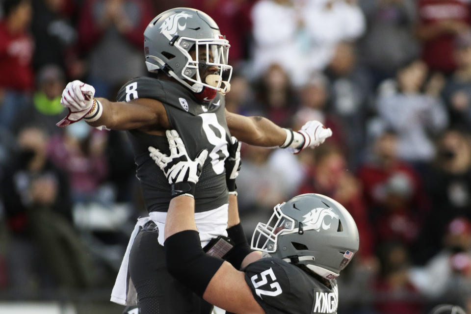 Washington State offensive lineman Jarrett Kingston (52) lifts wide receiver Calvin Jackson Jr. while celebrating Jackson's touchdown during the first half of an NCAA college football game against Stanford, Saturday, Oct. 16, 2021, in Pullman, Wash. (AP Photo/Young Kwak)