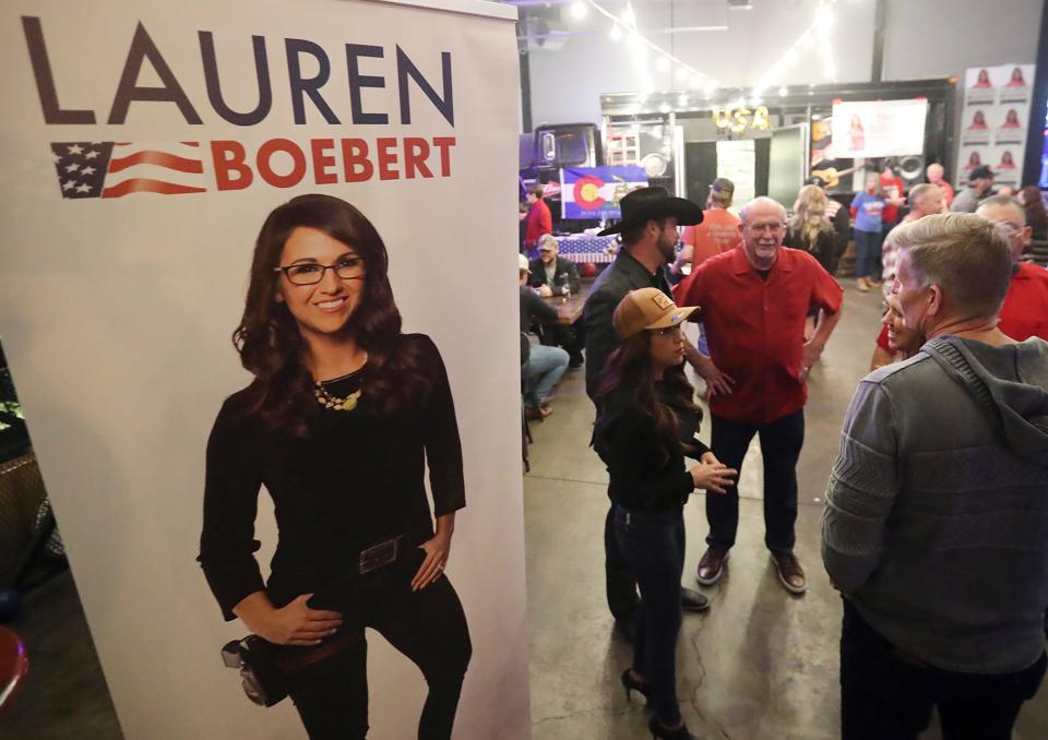 Incumbent U.S. Rep. Lauren Boebert, R-Colo., with her husband, Jayson Boebert, in black hat, talk with supporters during an election night party, Tuesday, Nov. 8, 2022, in Grand Junction, Colo.