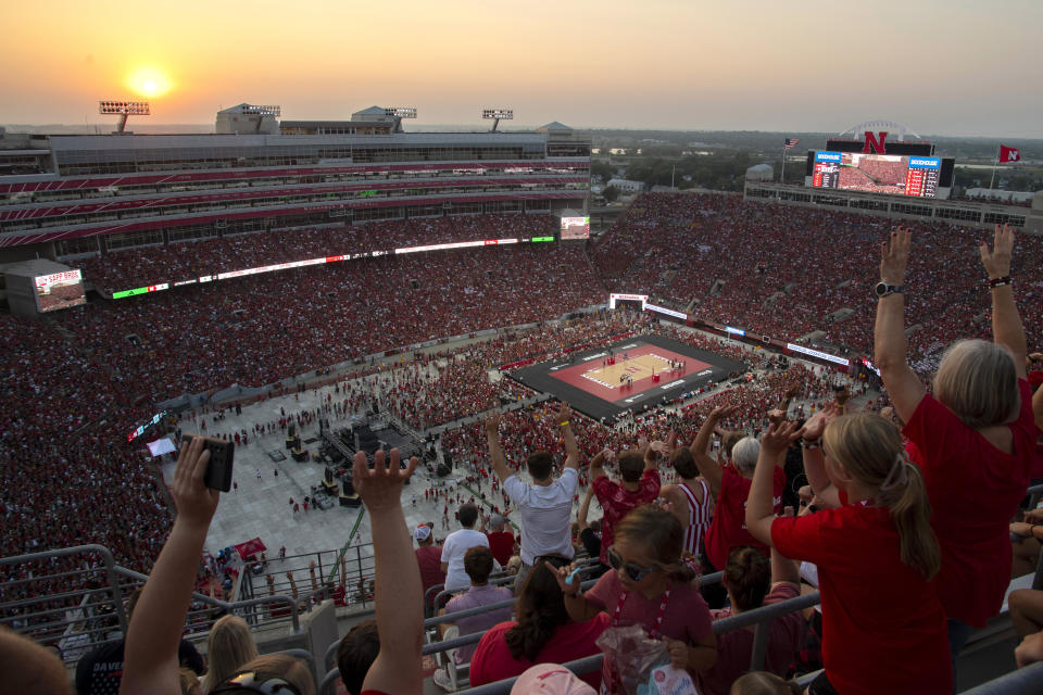 Volleyball fans do the wave during a break in the action during a college volleyball match between Omaha and Nebraska at Memorial Stadium on Wednesday, Aug. 30, 2023, in Lincoln, Neb. (Kenneth Ferriera/Lincoln Journal Star via AP)