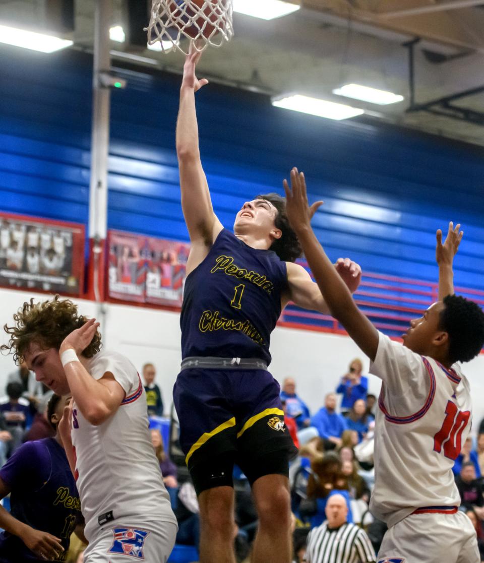 Peoria Christian's Malachi Persinger (1) moves to the basket against Peoria Heights in the first half of their high school basketball game Friday, Jan. 26, 2024 at Peoria Heights High School. The Chargers defeated the Patriots 60-58.