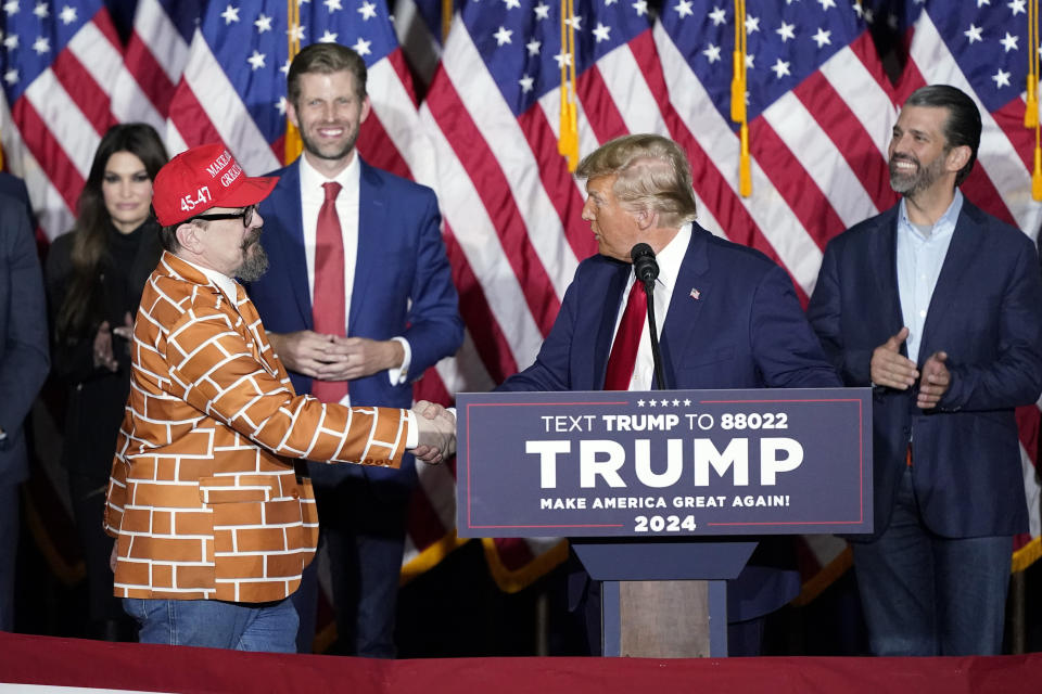 Republican presidential candidate former President Donald Trump shakes hands with supporter Blake Marnell as speaks at a caucus night party in Des Moines, Iowa, Monday, Jan. 15, 2024.(AP Photo/Pablo Martinez Monsivais)