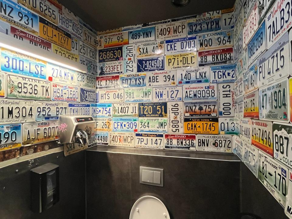 The bathroom decorated with US license plates inside American Bar in Iceland.