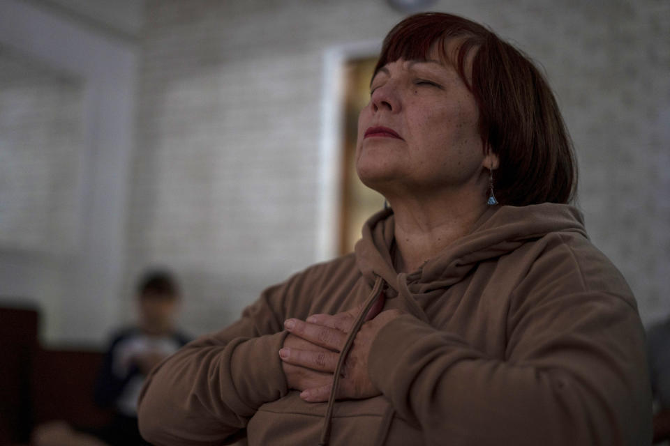 Valentyna Vandysheva, 61, practises yoga in the basement in Kramatorsk, Donetsk region, Ukraine, Thursday, Sept. 14, 2023. People in the front-line Ukrainian city of Kramatorsk gather three times a week for yoga session to alleviate the stress caused by Russia’s persistent shelling. (AP Photo/Hanna Arhirova)