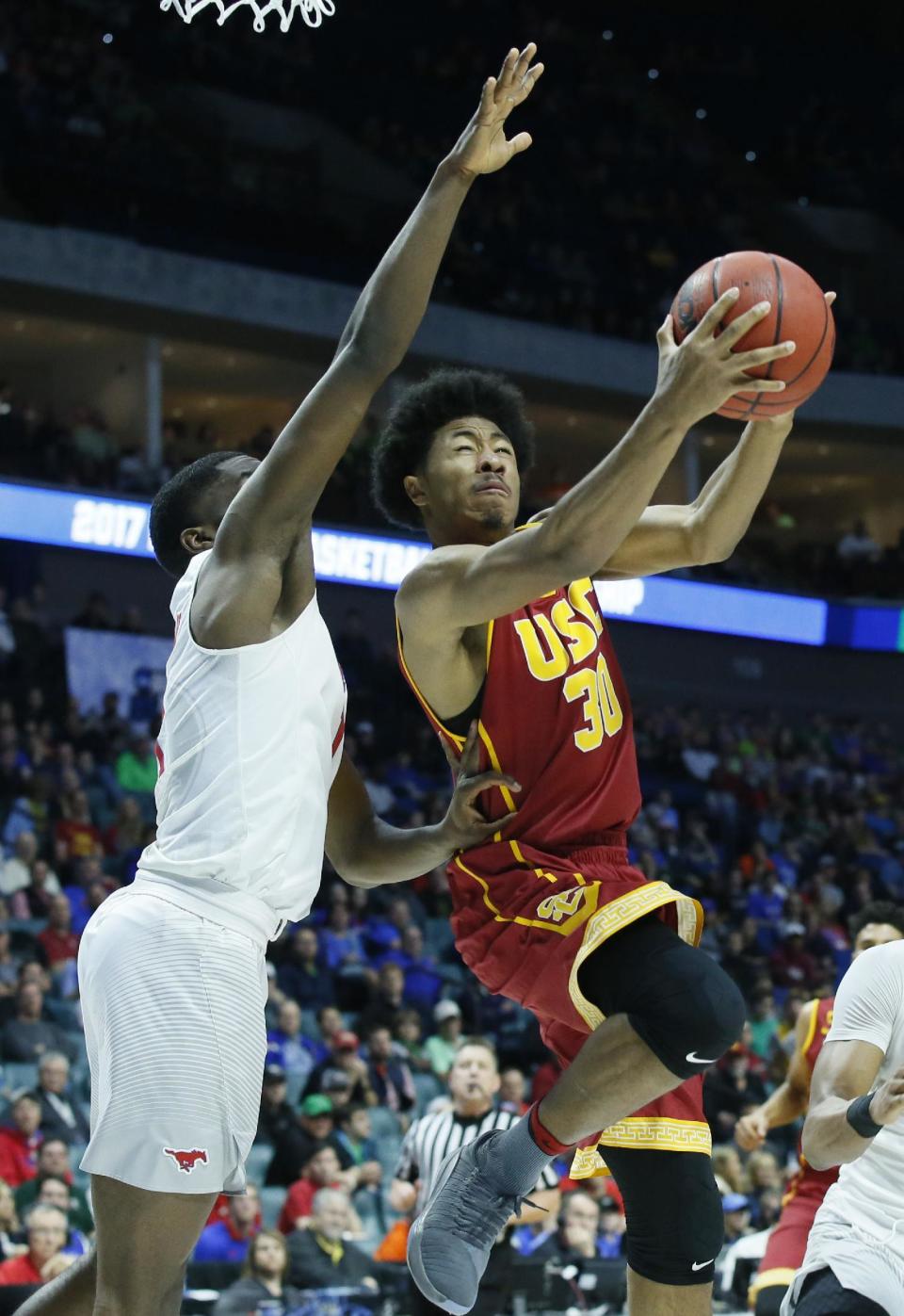 Southern California guard Elijah Stewart (30) shoots in front of Southern Methodist guard Shake Milton, left, in the first half of a first-round game in the men's NCAA college basketball tournament in Tulsa, Okla., Friday, March 17, 2017. (AP Photo/Sue Ogrocki)