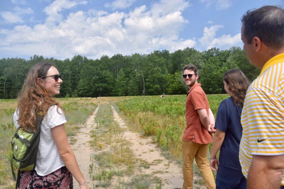 A group walks through the University of Michigan Biological Station UV field on Thursday, July 21, 2022.