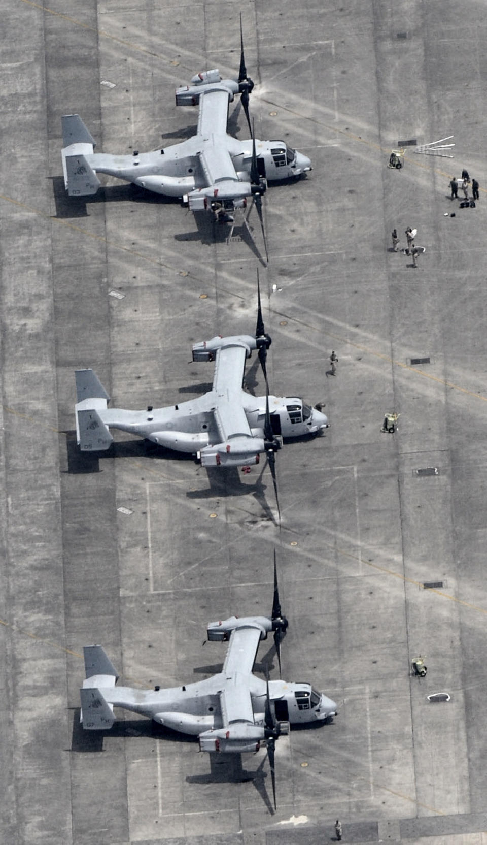 Three MV-22 Osprey sit in the tarmac at U.S. Marine Corps Air Station Iwakuni in Iwakuni, Yamaguchi Prefecture, western Japan, Monday, July 23, 2012. A shipload of the U.S. military's latest transport aircraft arrived in Japan on Monday amid protests over safety issues that have aggravated longstanding grassroots concern over the presence of American bases in the country. (AP Photo/Kyodo News) JAPAN OUT, MANDATORY CREDIT, NO LICENSING IN CHINA, HONG KONG, JAPAN, SOUTH KOREA AND FRANCE