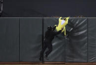 A security guard pulls a fan down from the center field fence who ran onto the field in the bottom of the six inning during an MLB basebal game between the Oakland Athletics and the San Francisco Giants at AT&T Park on May 18, 2012 in San Francisco, California. (Photo by Thearon W. Henderson/Getty Images)