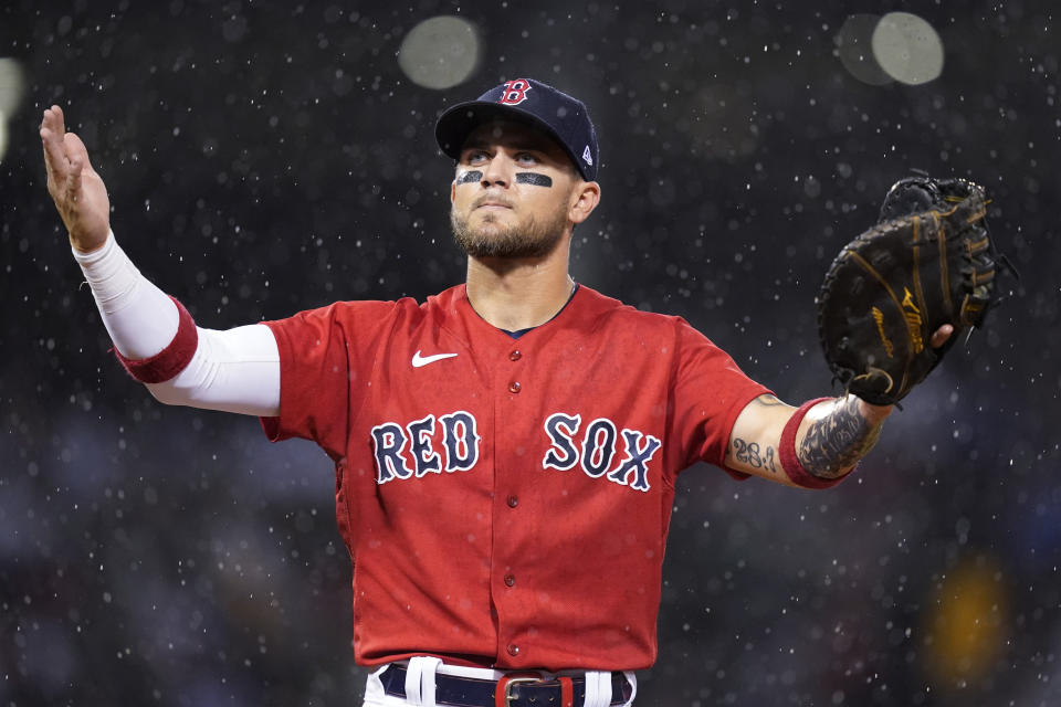 Boston Red Sox first baseman Michael Chavis gestures to fans as rain falls during the fifth inning of the team's baseball game against the Kansas City Royals at Fenway Park, Wednesday, June 30, 2021, in Boston. (AP Photo/Elise Amendola)