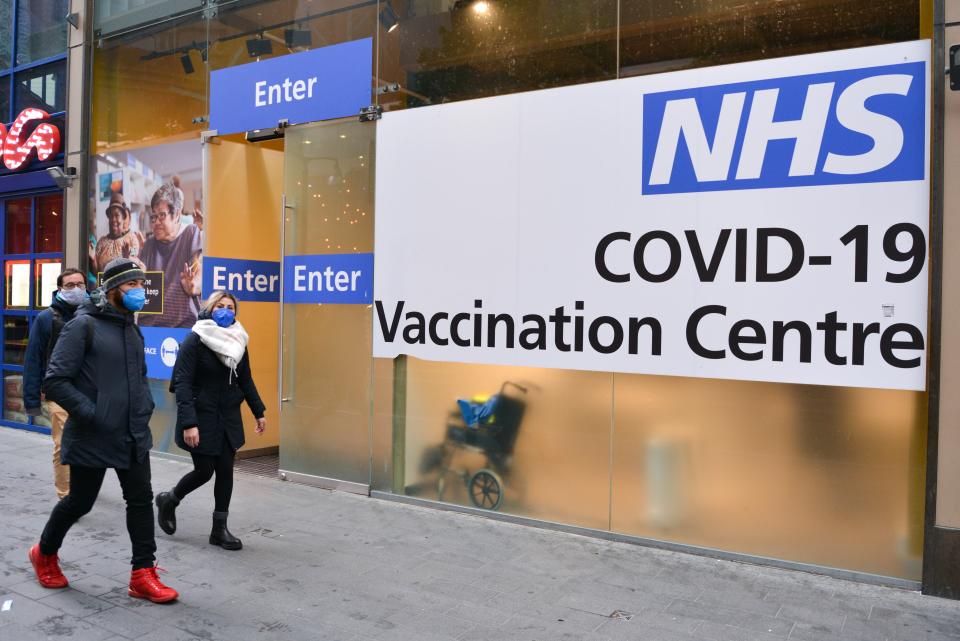 Pedestrians passing by the NHS Covid-19 Vaccination Centre in Westfield, Stratford. The UK reintroduces pandemic restrictions amidst emergence of the Omicron COVID-19 variant. Booster jabs are to be available in January. (Photo by Thomas Krych / SOPA Images/Sipa USA)
