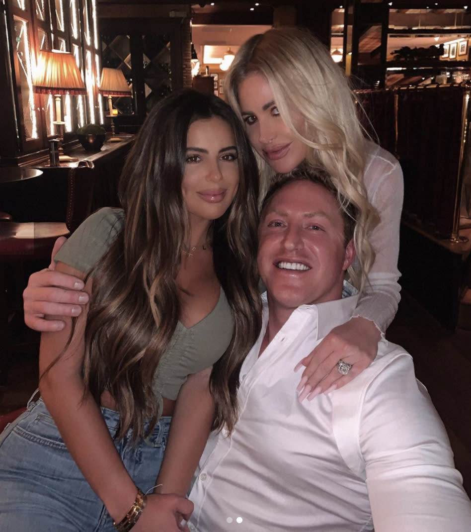 Brielle Biermann, Kim Zolciak-Biermann and Kroy Biermann pose Brielle on Kroy's lap.