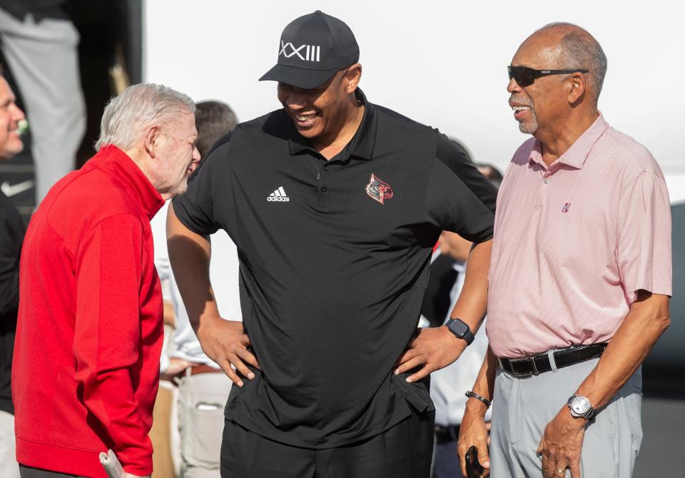 Kenny Payne, center, is greeted by his former coaches, Denny Crum, center, and Wade Houston, right, as Payne arrived in Louisville to taker over as men's basketball coach at U of L. March 17, 2022