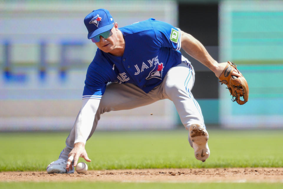 Toronto Blue Jays third baseman Matt Chapman fails to field a single hit by Cincinnati Reds' Spencer Steer in the second inning of a baseball game in Cincinnati, Sunday, Aug. 20, 2023. (AP Photo/Jeff Dean)