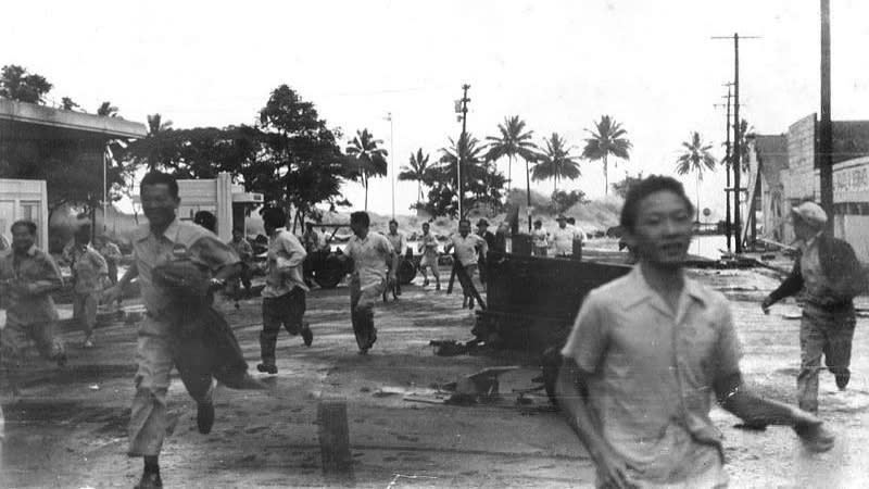 The large Unimark Island earthquake in 1946 caused a massive tsunami. Here we see a black and white photograph showing people running through the streets away from the approaching tsunami.