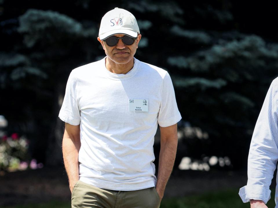 Satya Nadella wearing baseball cap and sunglasses walks at Sun Valley conference