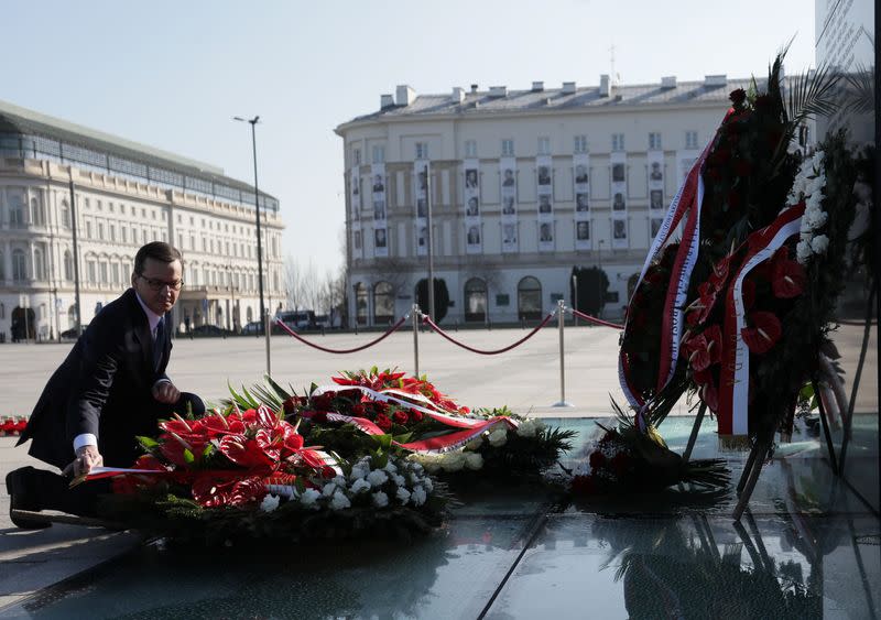 Poland's Prime Minister Mateusz Morawiecki lays a wreath on the monument to the victims of the Smolensk air disaster