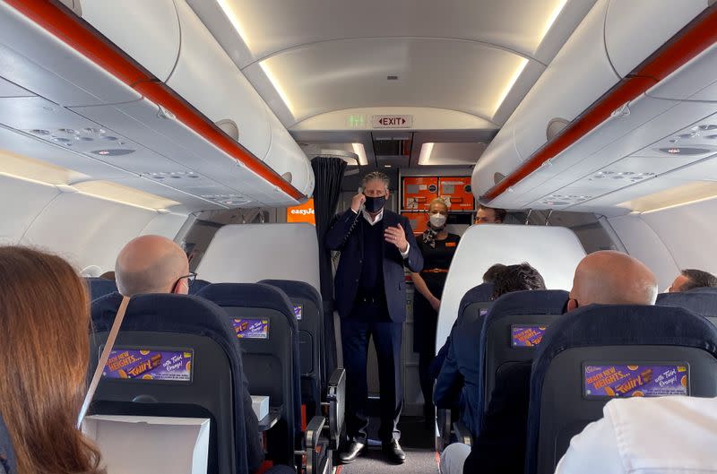 EasyJet CEO Johan Lundgren speaks to passengers during a flight to new Berlin-Brandenburg Airport (BER)