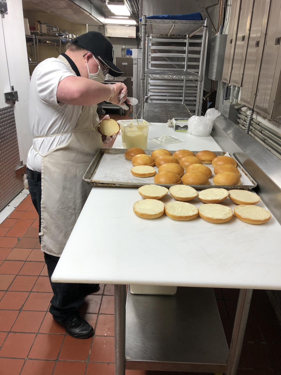 In addition to interacting with customers, Derek also gets to prepare food before it's served. (Courtesy Lafayette Industries)