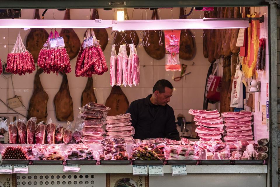 A butcher displays pork cuts at a fresh food market in Shanghai, China, on Thursday, Dec. 7, 2023. Photographer: Qilai Shen/Bloomberg