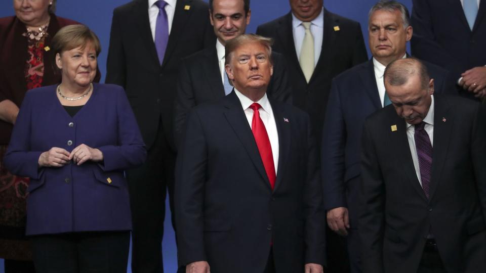 Then-U.S. President Donald Trump, center, stands during a NATO summit on Dec. 4, 2019, in Watford, England. (Steve Parsons/Getty Images)