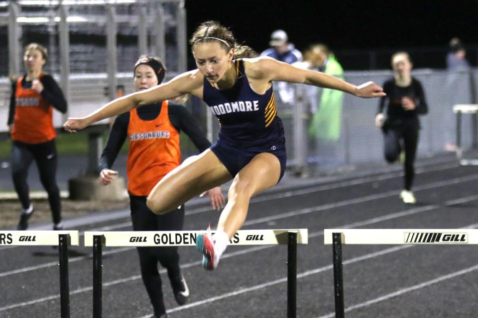 Woodmore's Azure Travis runs the 300 meter hurdles.