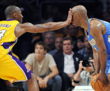 FILE - In this May 19, 2009, file photo, Los Angeles Lakers guard Kobe Bryant defends Denver Nuggets guard Chauncey Billups during the second half of Game 1 of the NBA basketball Western Conference finals, in Los Angeles. Bryant, the 18-time NBA All-Star who won five championships and became one of the greatest basketball players of his generation during a 20-year career with the Los Angeles Lakers, died in a helicopter crash Sunday, Jan. 26, 2020. (AP Photo/Mark J. Terrill, File)