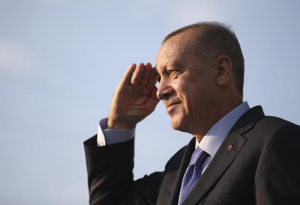 Turkish President Recep Tayyip Erdogan gives a style military salute toward his supporters during a rally in Kayseri, Turkey, Saturday, Oct. 19, 2019. Turkish Red Crescent says it has delivered humanitarian aid for 2000 people in Syrian town of Ras Al-Ayn and says it also provided aid to Tal Abyad and will continue to do so in areas cleared from Syrian Kurdish fighters.(Presidential Press Service via AP, Pool )