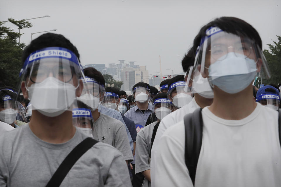 Interns and resident doctors attend a rally against the government medical policy in Seoul, South Korea, Friday, Aug. 7, 2020. Thousands of young doctors in South Korea began a strike Friday in protest of government medical policy, causing concerns about treatment of patients amid the coronavirus pandemic. (AP Photo/Ahn Young-joon)