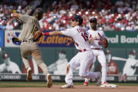 St. Louis Cardinals second baseman Tommy Edman tags out San Diego Padres' Adam Frazier, left, while shortstop Edmundo Sosa, right, watches as Edman turns the double play during the seventh inning of a baseball game Sunday, Sept. 19, 2021, in St. Louis. The Padres' Jurickson Profar was out at first. (AP Photo/Jeff Roberson)