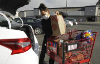 Instacart worker Saori Okawa loads groceries into her car for home delivery on Wednesday, July 1, 2020, in San Leandro, Calif. Okawa is one of an estimated 1.5 million so-called gig workers who make a living driving people to airports, picking out produce at grocery stores or providing childcare for working parents. But with the pandemic pummeling the global economy and U.S. unemployment reaching heights not seen since the Great Depression, gig workers are clamoring for jobs that often pay less while facing stiff competition from a crush of newly unemployed workers also attempting to patch together a livelihood until the economy recovers. (AP Photo/Ben Margot)