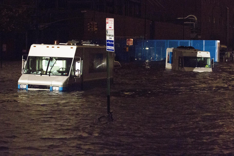 In this Monday, Oct. 29, 2012, file photo, Consolidated Edision trucks are submerged on 14th Street near the ConEd power plant in New York. After a gigantic wall of water defied elaborate planning and swamped underground electrical equipment at a Consolidated Edison substation in Manhattan's East Village, about 250,000 lower Manhattan customers were left without power. (AP Photo/John Minchillo)