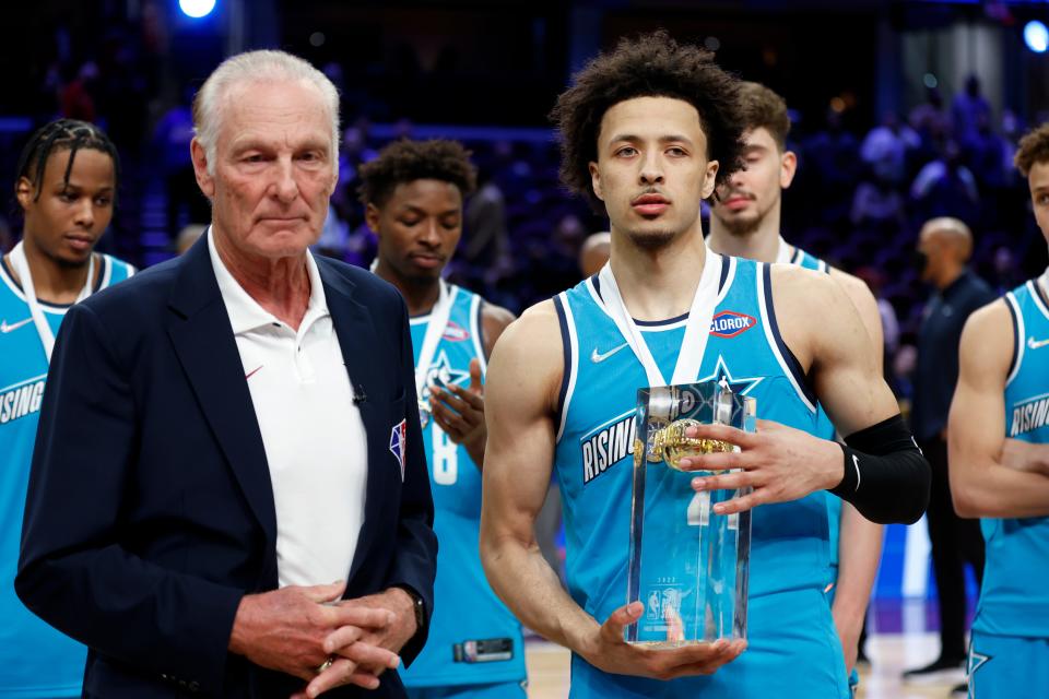 Team Barry's Cade Cunningham, front right, of the Detroit Pistons, stands with honorary coach Rick Barry after being named MVP of the NBA Rising Stars event, Friday, Feb. 18, 2022, in Cleveland. Team Barry won the event.