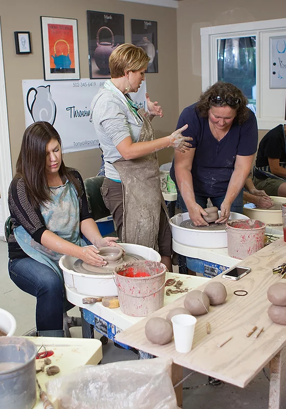 Tonya Johnson, center, teaches a pottery class. Johnson is a career artist, who owns Payne Street Pottery.