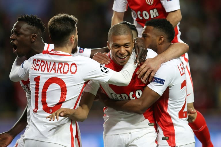 Monaco's Kylian Mbappe (C) and teammates celebrate his opening goal during their UEFA Champions League 2nd leg quarter-final football match against Borussia Dortmund on April 19, 2017 at the Louis II stadium in Monaco