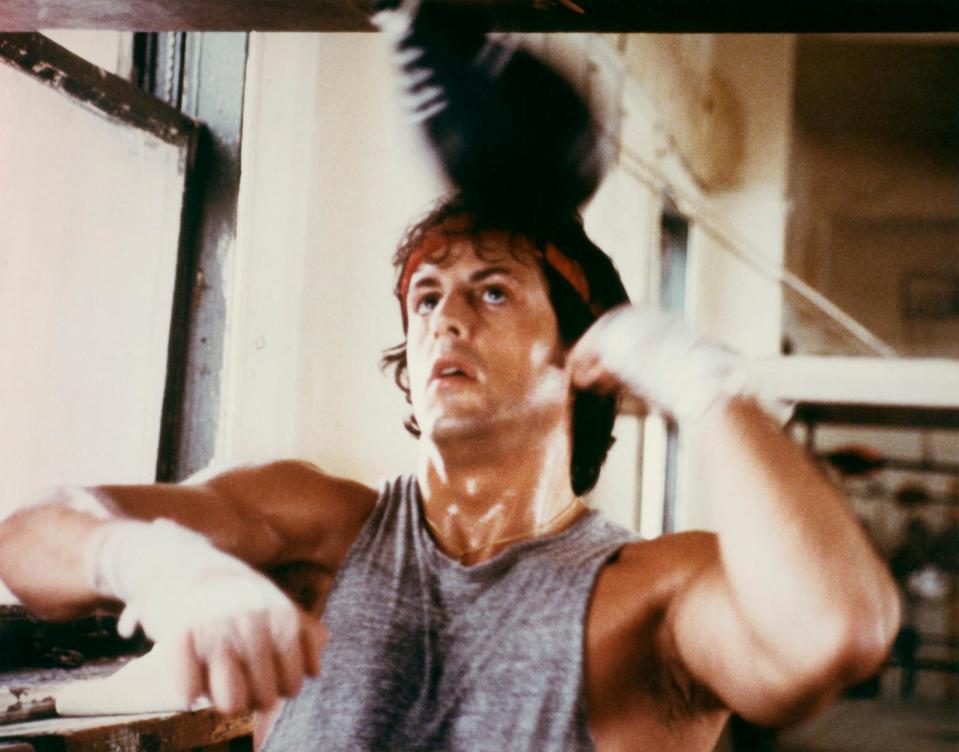 PHOTO: Sylvester Stallone as boxer Rocky Balboa trains with punchbag in the 1976 film 'Rocky.' (Screen Archives/Getty Images)