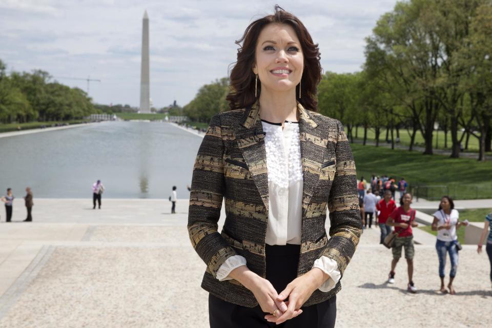 Actress Bellamy Young, who plays first lady Mellie Grant in the television show Scandal, tours the National Mall by the reflecting pool with the Washington Monument in the background, in Washington, Friday, May 2, 2014. The 44-year-old actress is visiting Washington for the first time since she started playing Mellie Grant in “Scandal” and will attend the White House correspondents’ dinner this weekend. On Friday, she joined a tour with a nonprofit group working to restore the National Mall. She stepped gingerly in heels around potholes, mud and broken sidewalks in an area called Constitution Gardens. (AP Photo/Jacquelyn Martin)