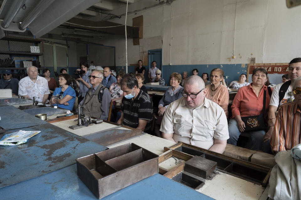 People sit in a workshop in a manufacturing plant where visually impaired people used to work until it was shuttered following a Russian air assault in Kyiv, Ukraine, on May 30, 2023. Losing the place of work is just one of a multitude of challenges that people with visual impairments face across Ukraine since Russia launched a full-scale invasion in February 2022. (AP Photo/Roman Hrytsyna)