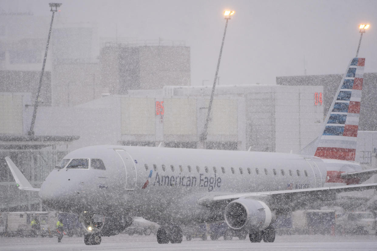 An American Eagle plane taxis during a snow storm at Seattle-Tacoma International Airport (SEA) in Seattle on Tuesday, Dec. 20, 2022.  (David Ryder / Bloomberg via Getty Images)