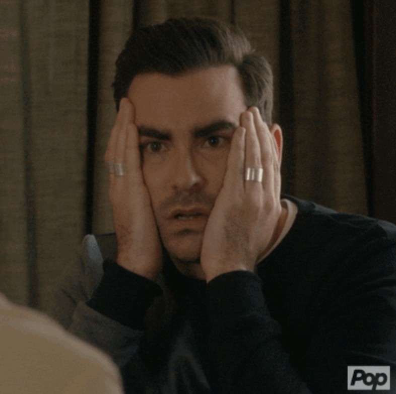 David from "Schitt's Creek" putting his hands on his face in disbelief