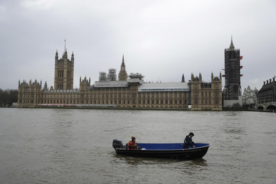 FILE - In this Wednesday, Jan. 31, 2018 file photo, people aboard a boat make way past the Houses of Parliament with Big Ben's clock tower, the Elizabeth Tower covered in scaffolding for repairs in London. British lawmakers on Thursday July 18, 2019, put a substantial roadblock in the path of any attempt by a Brexit-backing prime minister to take the country out of the European Union without a divorce deal. (AP Photo/Matt Dunham, File)