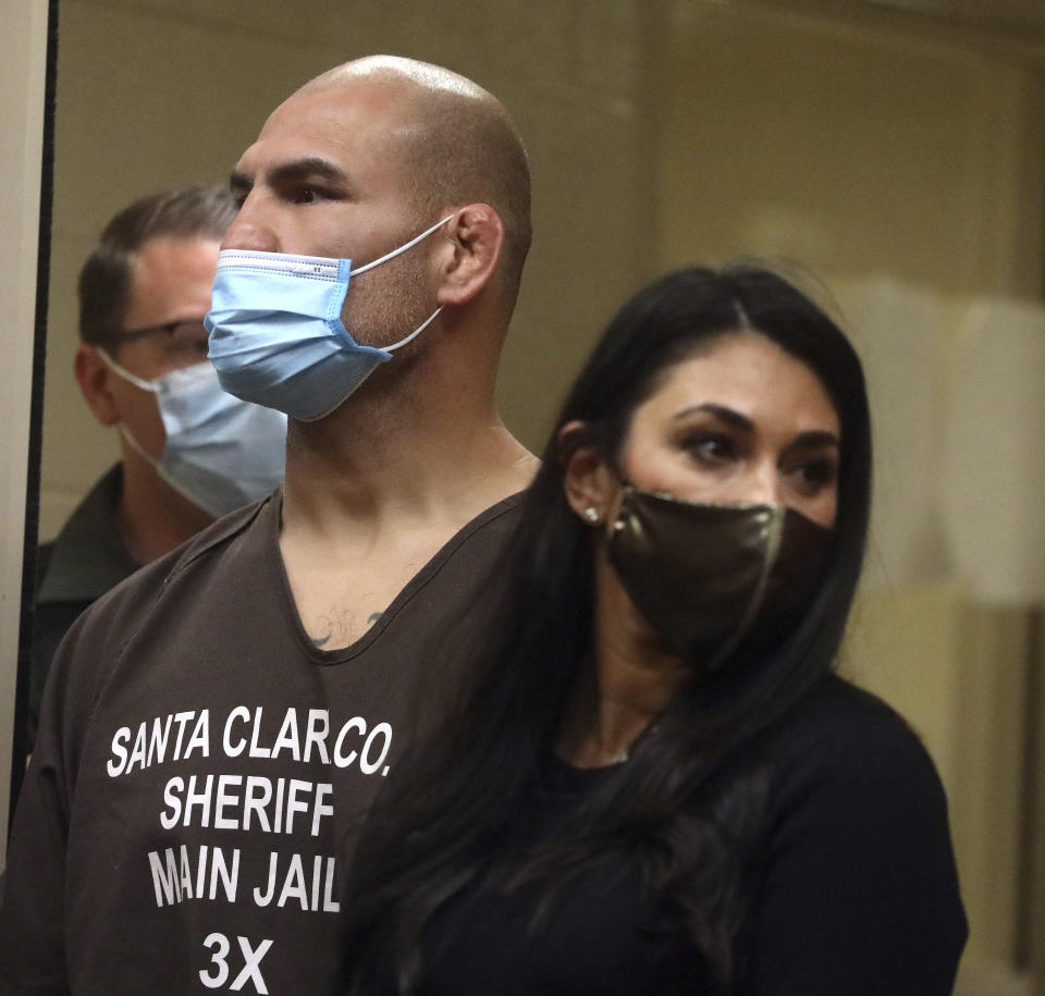 Former UFC heavyweight champion Cain Velasquez, left, with his attorney Alexandra Kazarian, right, makes an initial court appearance at the Santa Clara County Hall of Justice on Wednesday, March 2, 2022, in San Jose, Calif. Velasquez was arrested Monday on suspicion of attempted murder after he allegedly shot a man in Northern California, police said. (Aric Crabb/Bay Area News Group via AP, Pool)