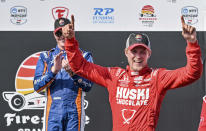 PNC Chip Ganassi Racing driver Scott Dixon, left, claps as Huski Chocolate Chip Ganassi Racing driver Marcus Ericsson celebrates on the Victory Lane podium after winning the Grand Prix of St. Petersburg auto race Sunday, March 5, 2023, in St. Petersburg, Fla. (AP Photo/Steve Nesius)