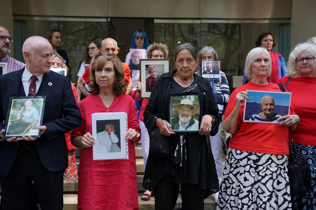 People hold pictures of loved ones lost during the pandemic outside Dorland House in London where the inquiry is hearing evidence for its first investigation (Module 1) examining if the pandemic was properly planned for and 