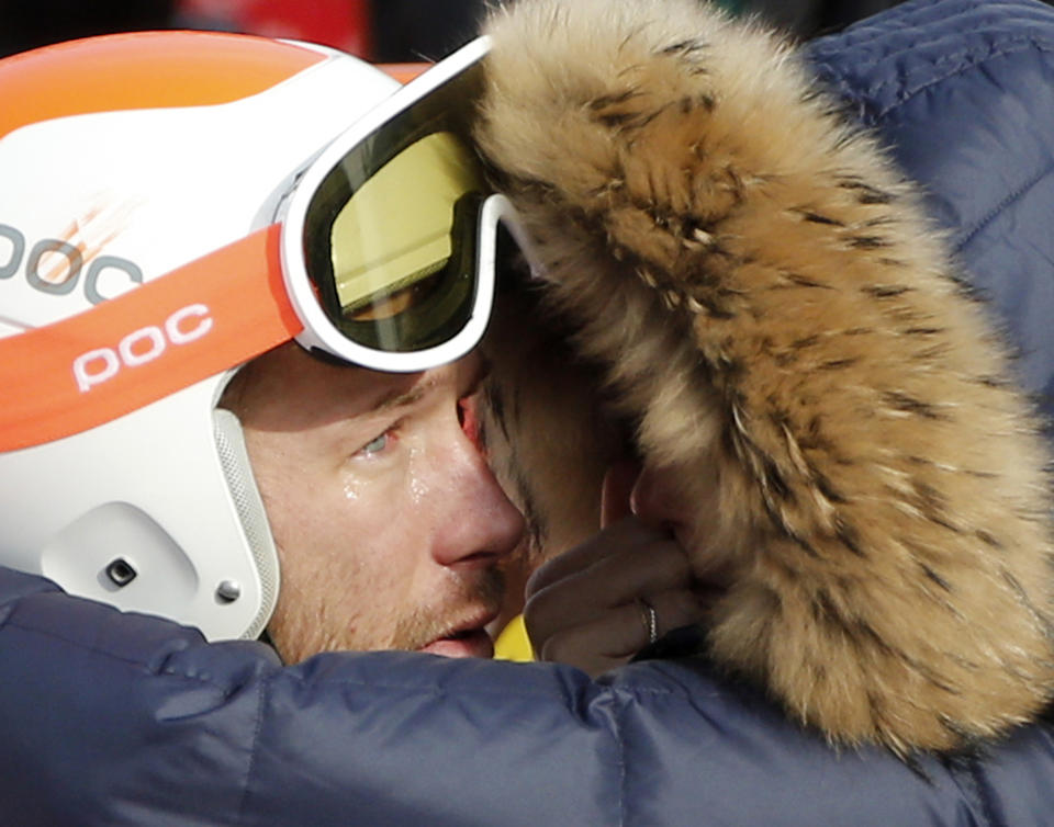 Men's super-G joint bronze medal winner Bode Miller of the United States is consoled by his wife, Morgan, at the Sochi 2014 Winter Olympics, Sunday, Feb. 16, 2014, in Krasnaya Polyana, Russia. (AP Photo/Christophe Ena)