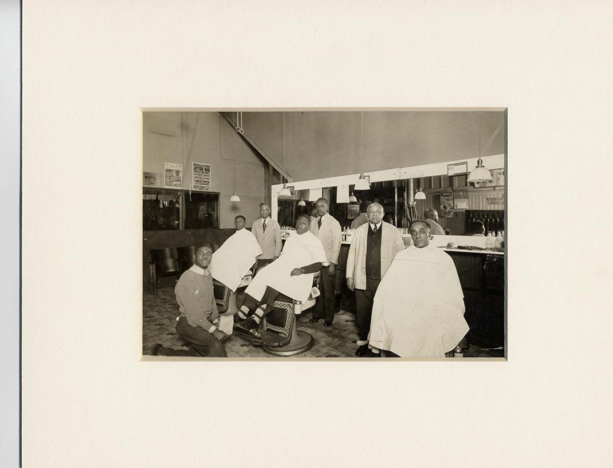 The photographs of Taylor Matthews often pictured businesses in Canton's African American community. Here, he captured a photo of a lineup of Black barbers.