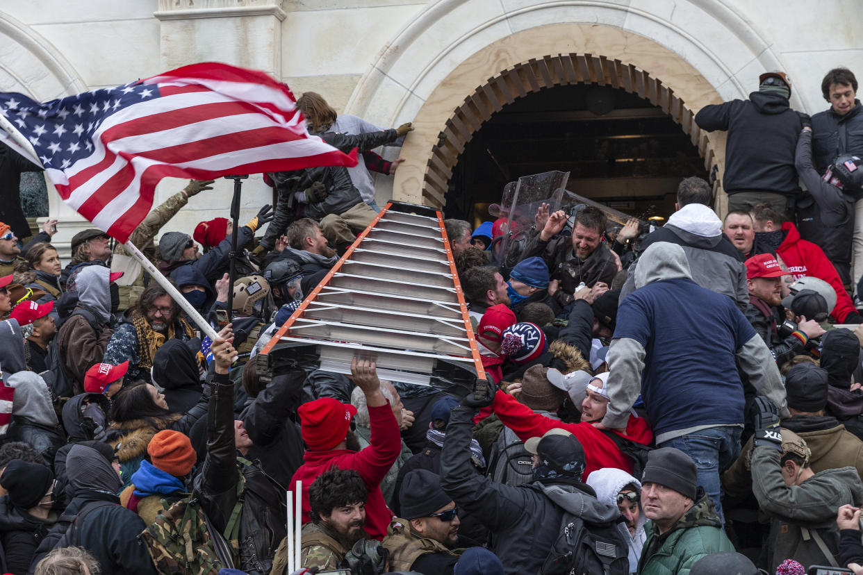 Rioters clash with police using big ladder trying to enter Capitol building through the front doors on Jan. 6, 2021. Rioters broke windows and breached the Capitol building in an attempt to overthrow the results of the 2020 election. (Lev Radin/Pacific Press/LightRocket via Getty Images)